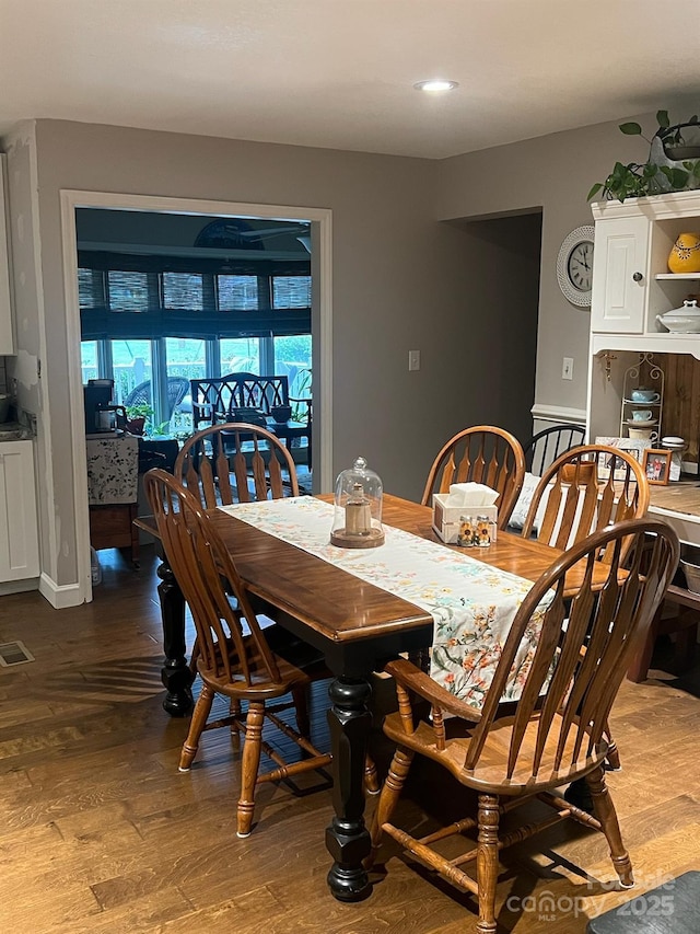 dining space with visible vents and dark wood-style flooring