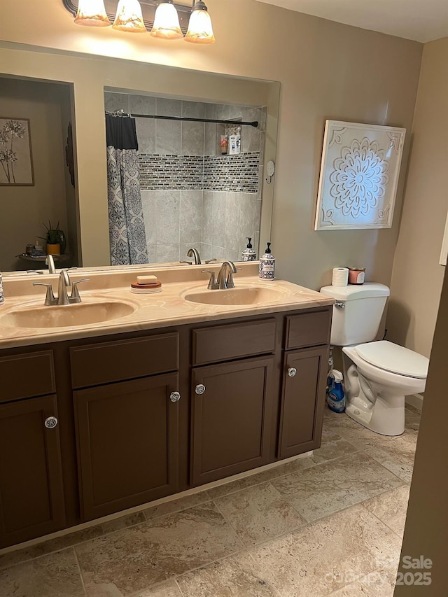 full bathroom with toilet, a shower with curtain, double vanity, and a sink