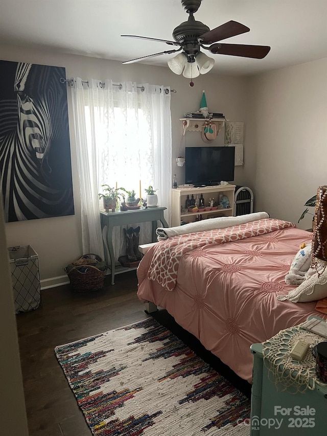 bedroom featuring a ceiling fan and wood finished floors