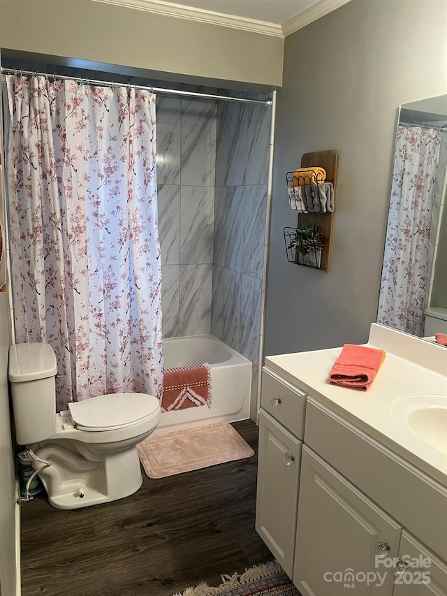 bathroom featuring toilet, wood finished floors, shower / bathtub combination with curtain, crown molding, and vanity