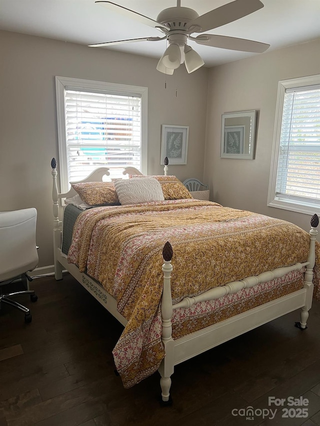 bedroom featuring dark wood-style floors, ceiling fan, and baseboards