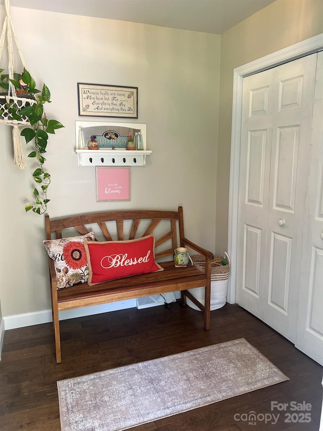 interior space featuring wood finished floors and baseboards