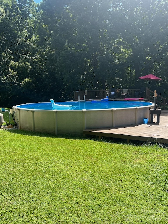 outdoor pool with a yard