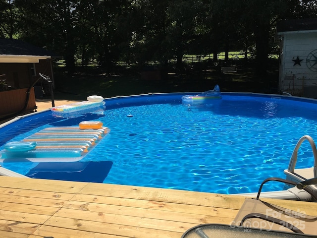 outdoor pool with a wooden deck