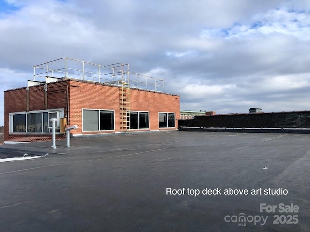 view of building exterior featuring uncovered parking