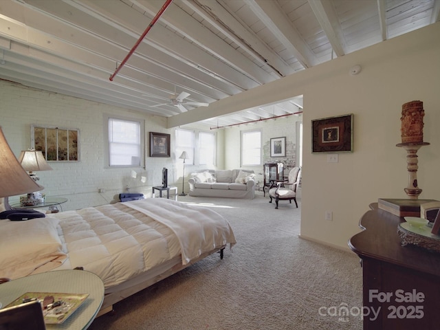 carpeted bedroom with beamed ceiling, baseboards, and brick wall