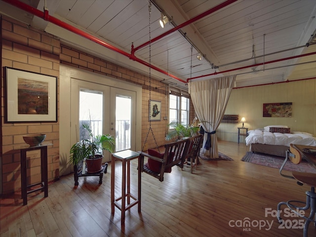 interior space featuring track lighting, french doors, and hardwood / wood-style floors