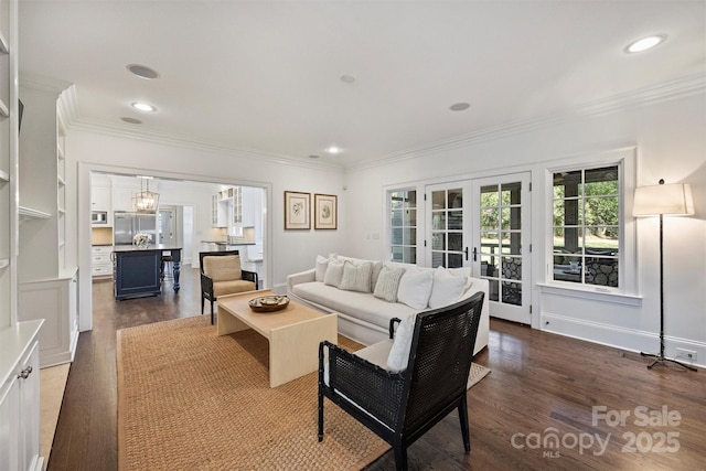 living area featuring dark wood finished floors, crown molding, and french doors