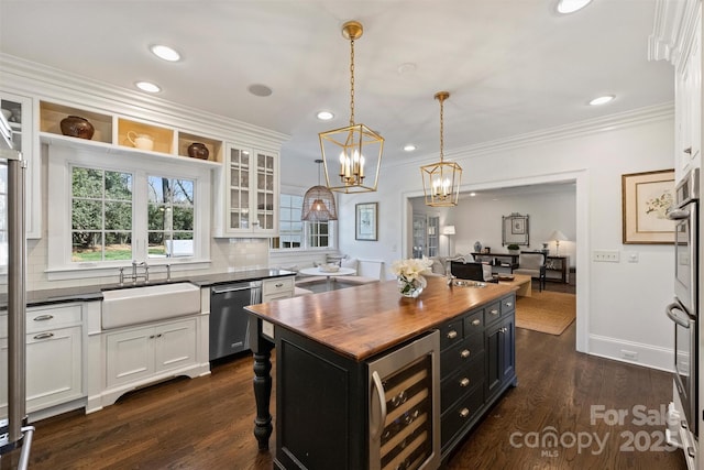 kitchen with beverage cooler, white cabinets, dishwasher, butcher block countertops, and a sink