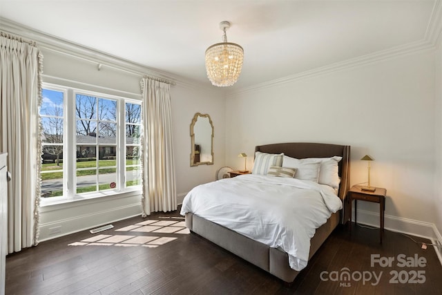 bedroom with dark wood-style floors, visible vents, and ornamental molding