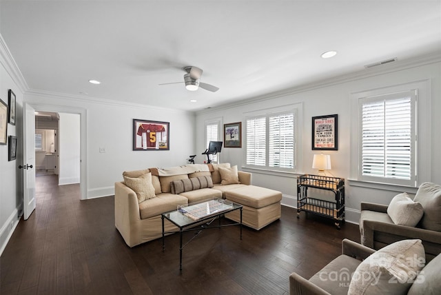 living room featuring dark wood-style floors, visible vents, ornamental molding, and baseboards