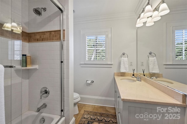 full bath featuring a healthy amount of sunlight, crown molding, and toilet