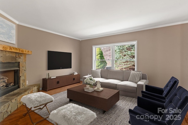 living area featuring crown molding, a stone fireplace, and wood finished floors