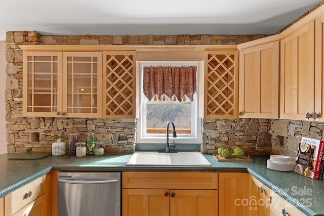 kitchen featuring dishwasher, light brown cabinets, and a sink