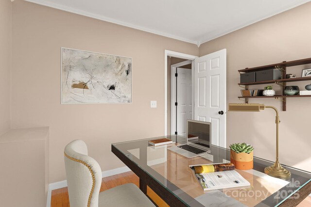 home office with ornamental molding, wood finished floors, and baseboards