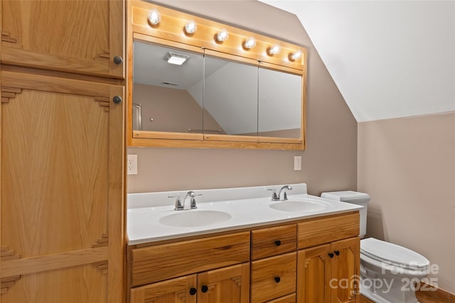 full bathroom with lofted ceiling, a sink, toilet, and double vanity