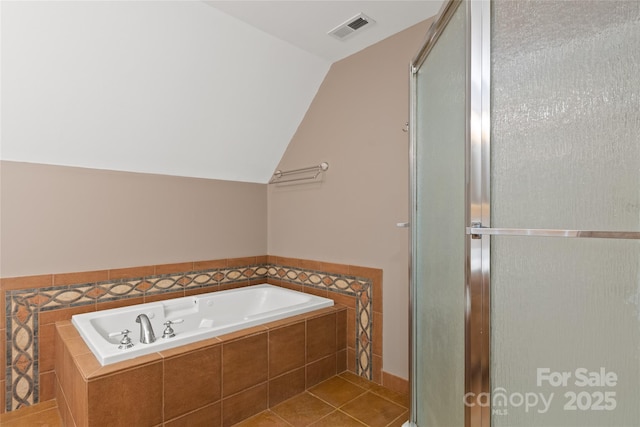 bathroom with a stall shower, visible vents, a garden tub, tile patterned flooring, and vaulted ceiling