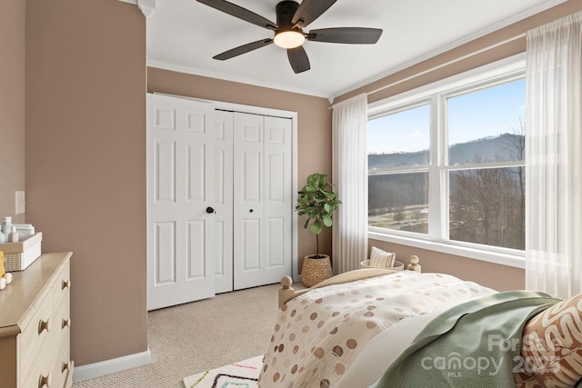 bedroom featuring light carpet, a closet, multiple windows, and crown molding