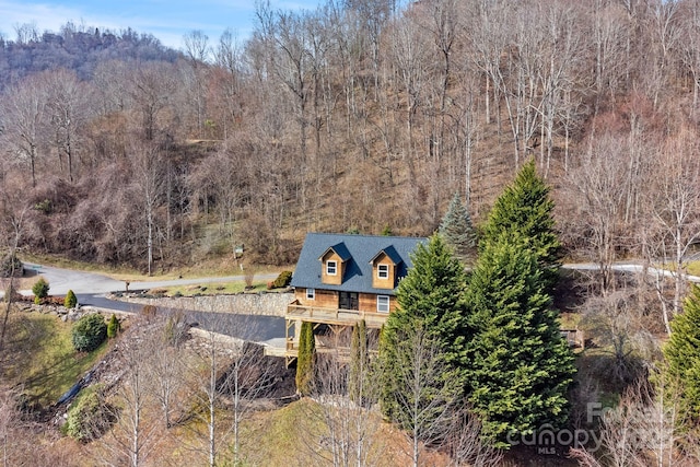 birds eye view of property with a wooded view