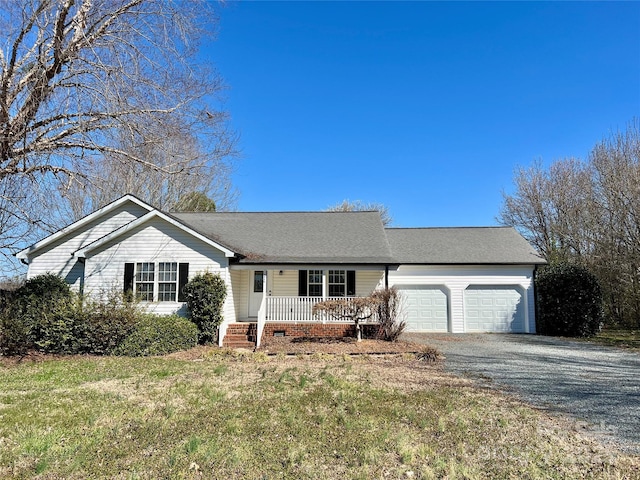 ranch-style home with a garage, a front yard, gravel driveway, and covered porch