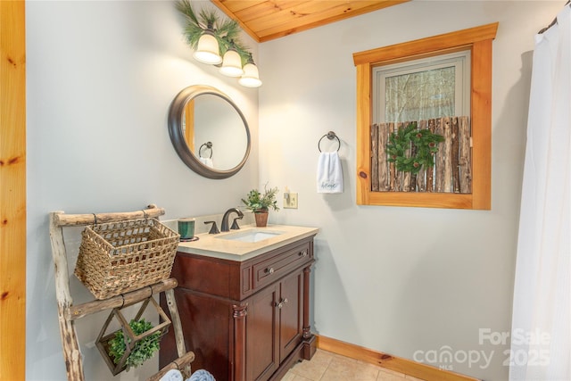 bathroom featuring tile patterned flooring, baseboards, and vanity