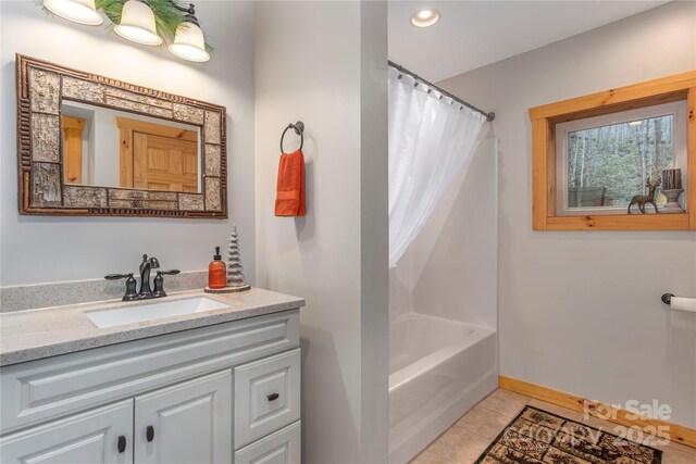 bathroom with recessed lighting, vanity, baseboards, and tile patterned floors