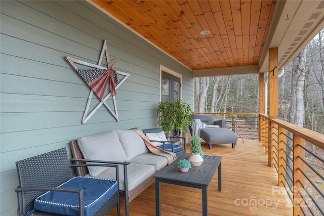 wooden terrace with outdoor lounge area