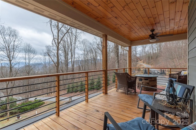 wooden deck featuring a ceiling fan