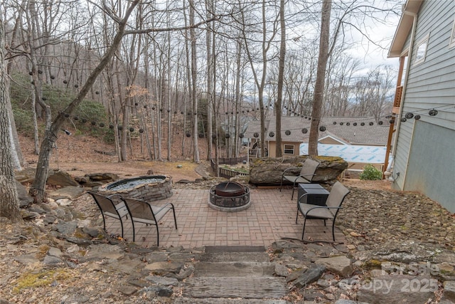 view of patio with a fire pit