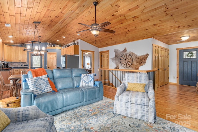 living room with a chandelier, wooden ceiling, vaulted ceiling, and light wood finished floors