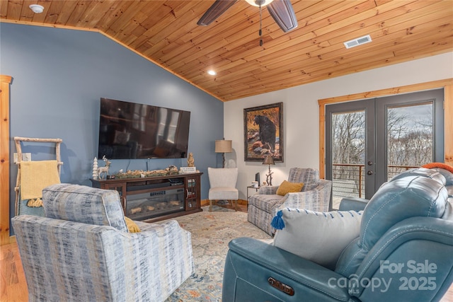 living room featuring a ceiling fan, lofted ceiling, french doors, and wooden ceiling