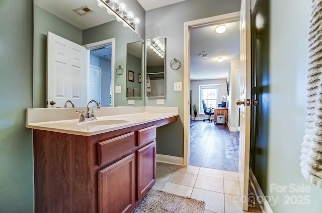 bathroom featuring vanity, tile patterned flooring, visible vents, and baseboards