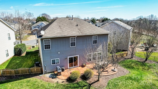 back of house with a patio area, a lawn, and fence