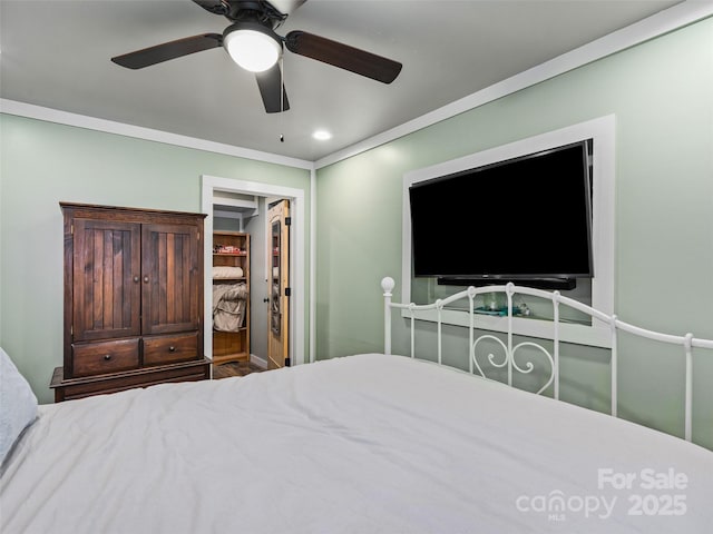 bedroom with a closet, crown molding, ceiling fan, recessed lighting, and a spacious closet