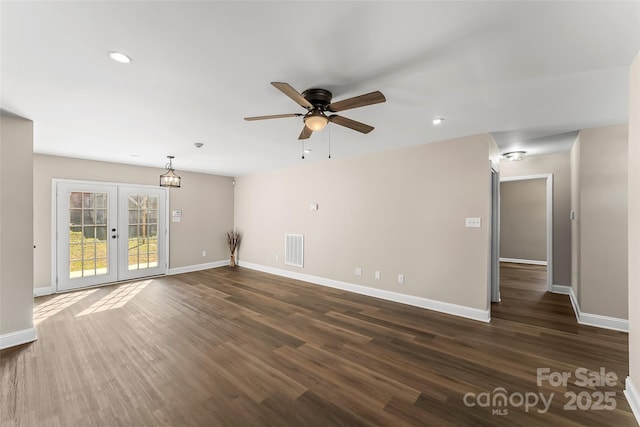 unfurnished living room with ceiling fan, french doors, dark wood-style flooring, visible vents, and baseboards