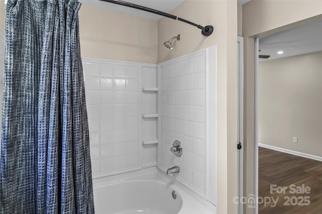 bathroom with shower / bath combo with shower curtain, baseboards, and wood finished floors