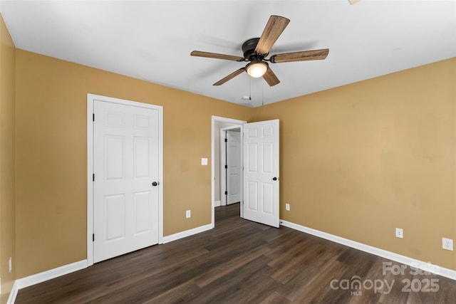 unfurnished bedroom with baseboards, ceiling fan, and dark wood-style flooring
