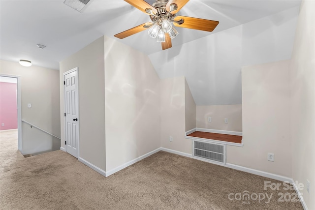 additional living space with carpet floors, ceiling fan, and visible vents