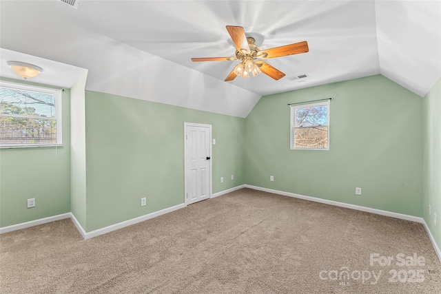 bonus room with carpet floors, visible vents, lofted ceiling, baseboards, and ceiling fan