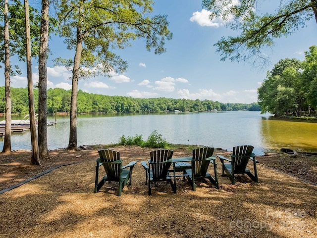 exterior space with a water view and a wooded view