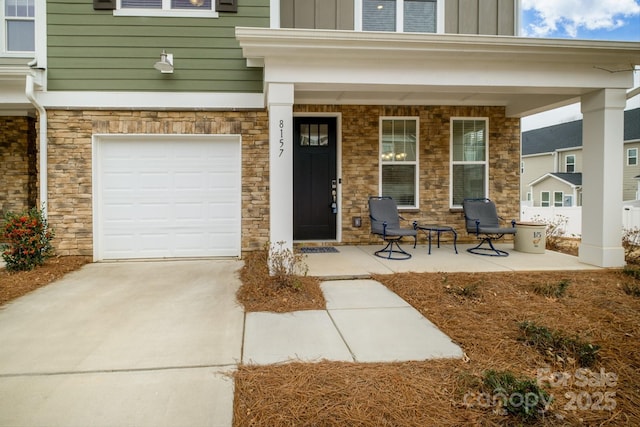 property entrance with a porch, board and batten siding, and concrete driveway