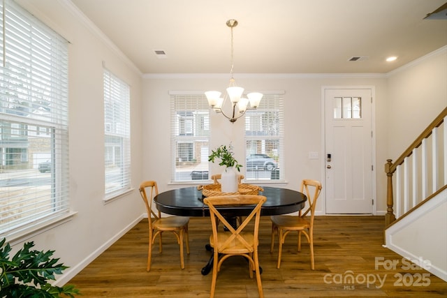 dining room featuring visible vents, crown molding, stairway, and wood finished floors