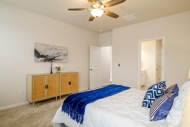 carpeted bedroom with ceiling fan, baseboards, and ensuite bathroom