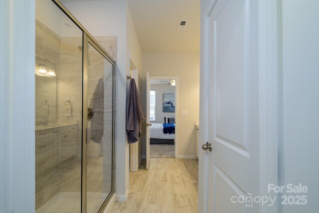 full bathroom featuring ensuite bath, visible vents, baseboards, and a shower stall