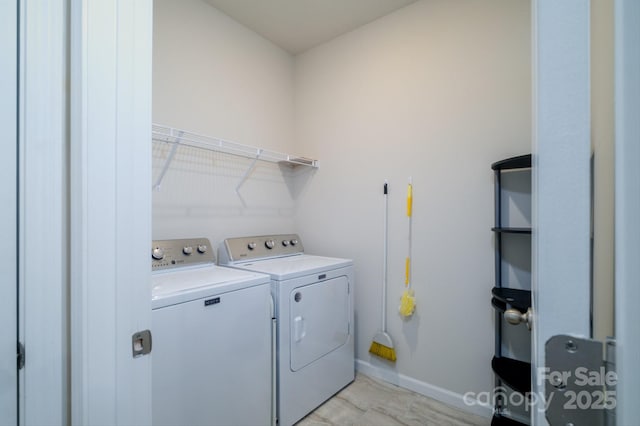 laundry room featuring laundry area, washing machine and clothes dryer, and baseboards