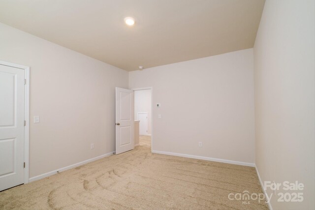 spare room with carpet flooring and baseboards