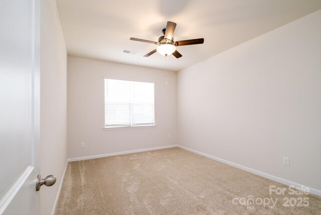 empty room with baseboards, carpet, visible vents, and a ceiling fan