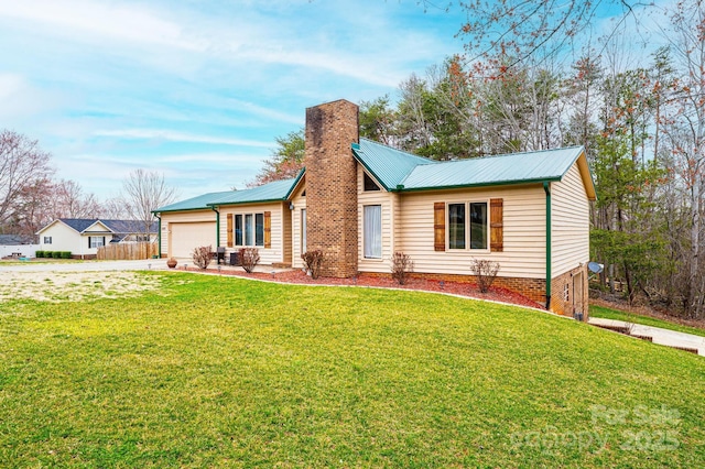 single story home featuring a chimney, metal roof, a garage, and a front yard