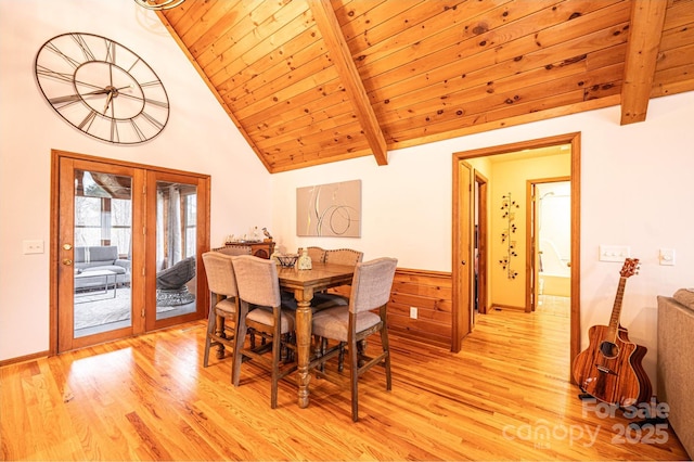 dining area with beam ceiling, light wood-style floors, wood ceiling, and high vaulted ceiling