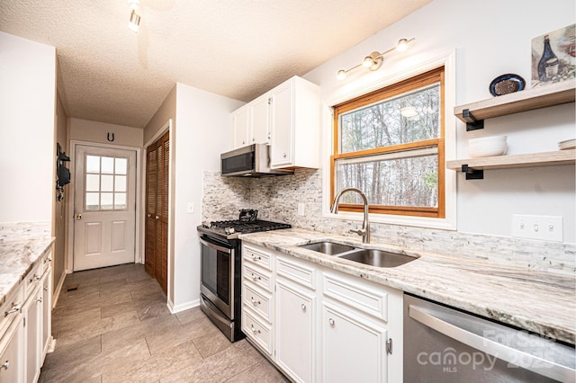 kitchen with a sink, stainless steel appliances, plenty of natural light, and white cabinets